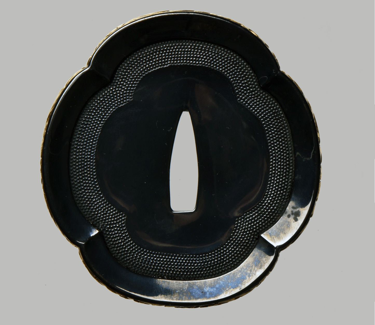 Tsuba with Black Lacquered Surface and Gilded Rim Decoration