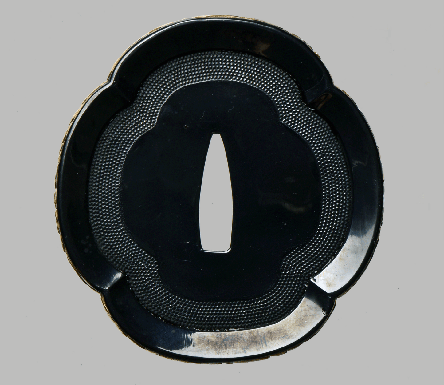 Tsuba with Black Lacquered Surface and Gilded Rim Decoration