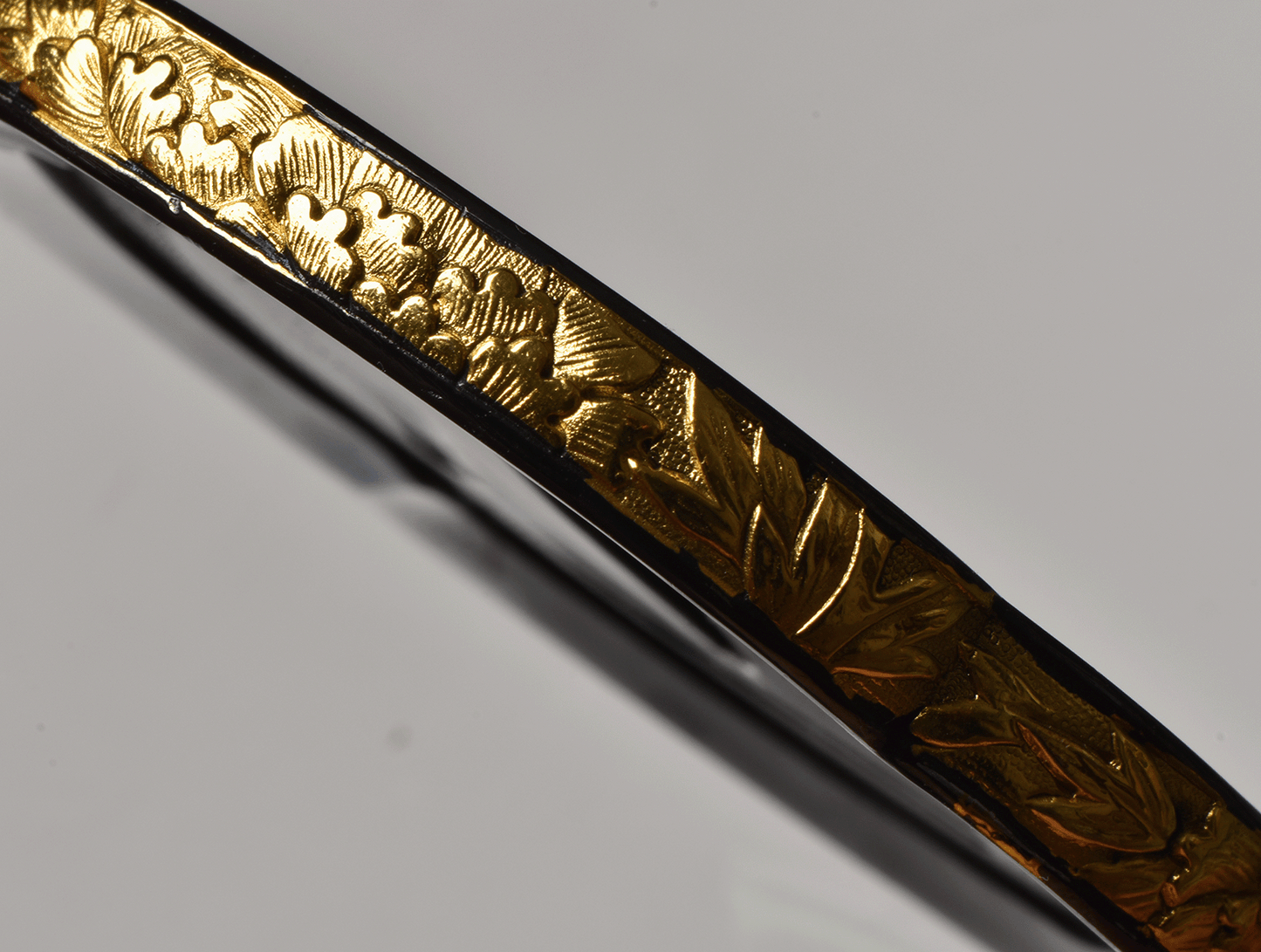 Tsuba with Black Lacquered Surface and Gilded Rim Decoration