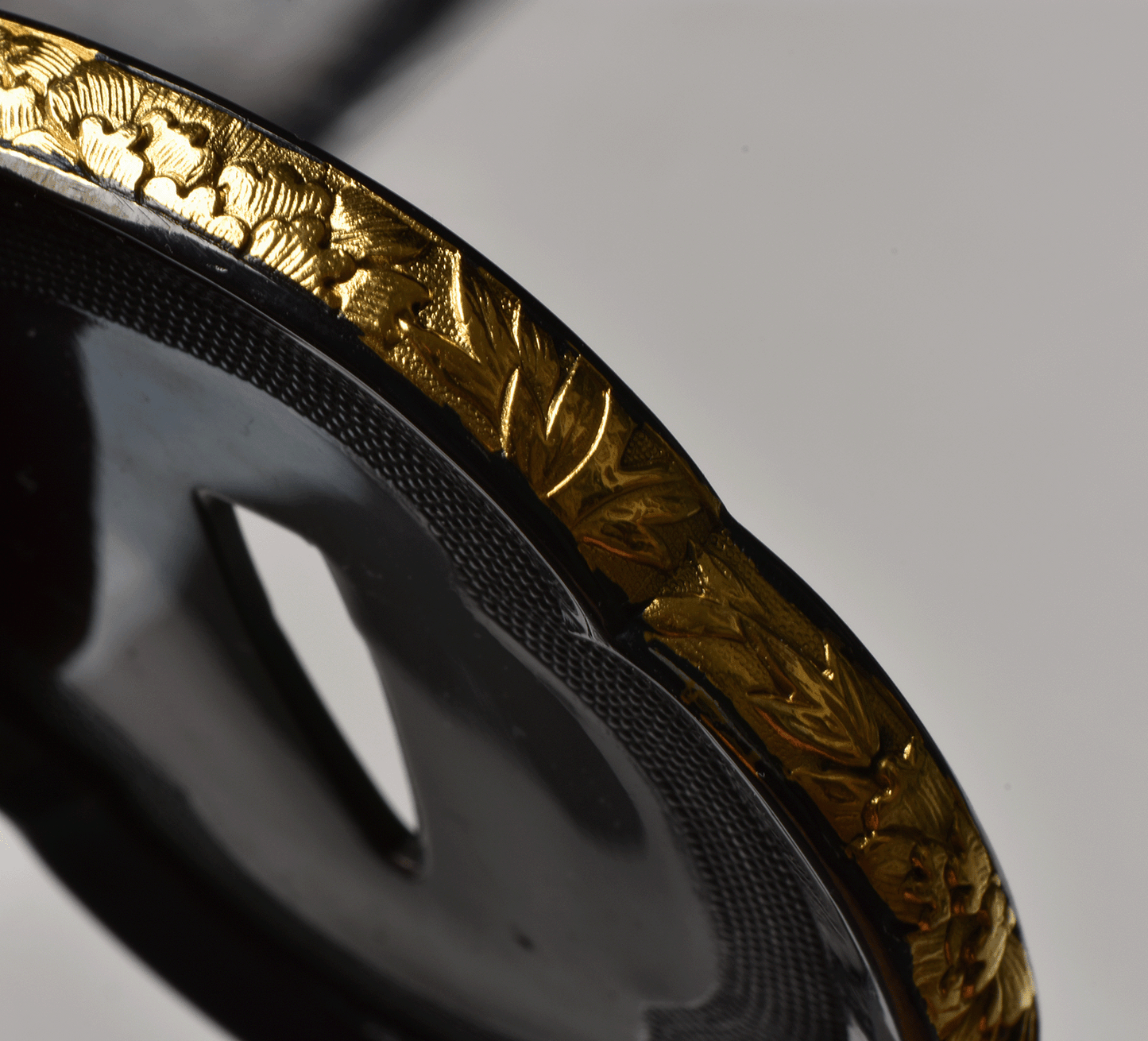 Tsuba with Black Lacquered Surface and Gilded Rim Decoration