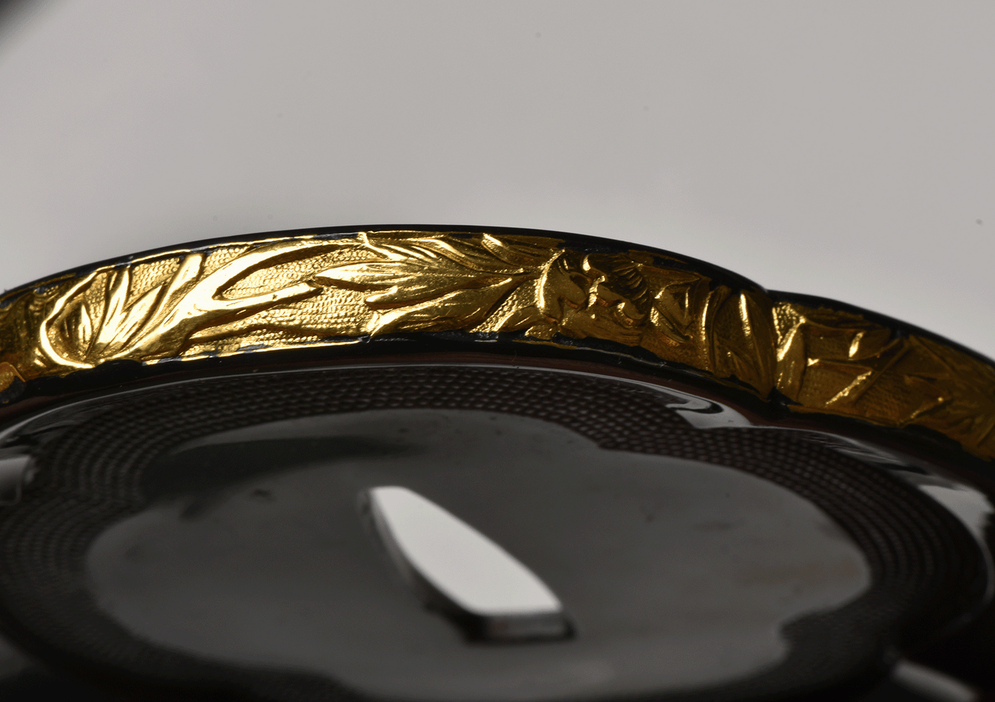 Tsuba with Black Lacquered Surface and Gilded Rim Decoration